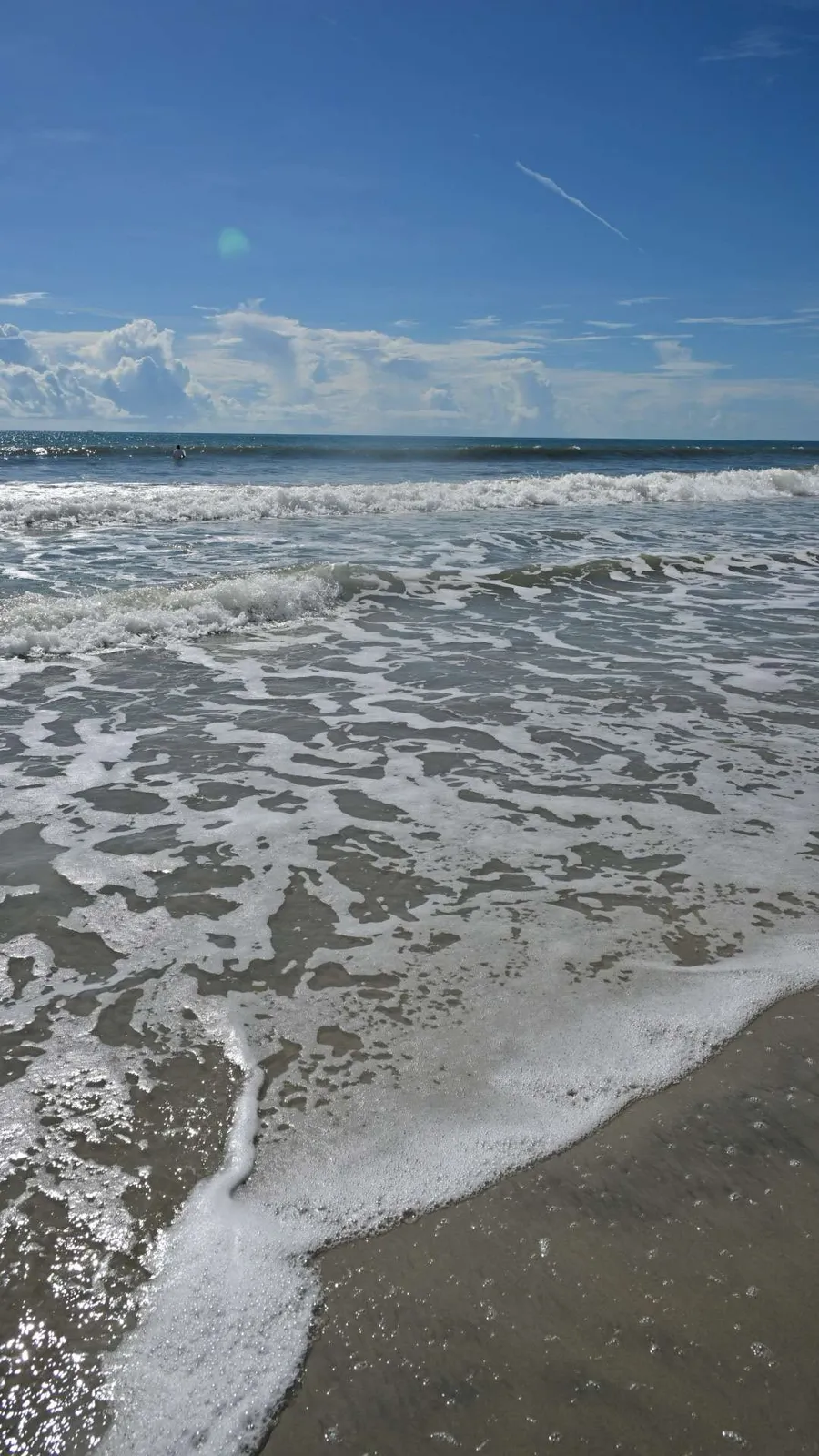 Atlantic foam drawing back over the sand at the water’s edge