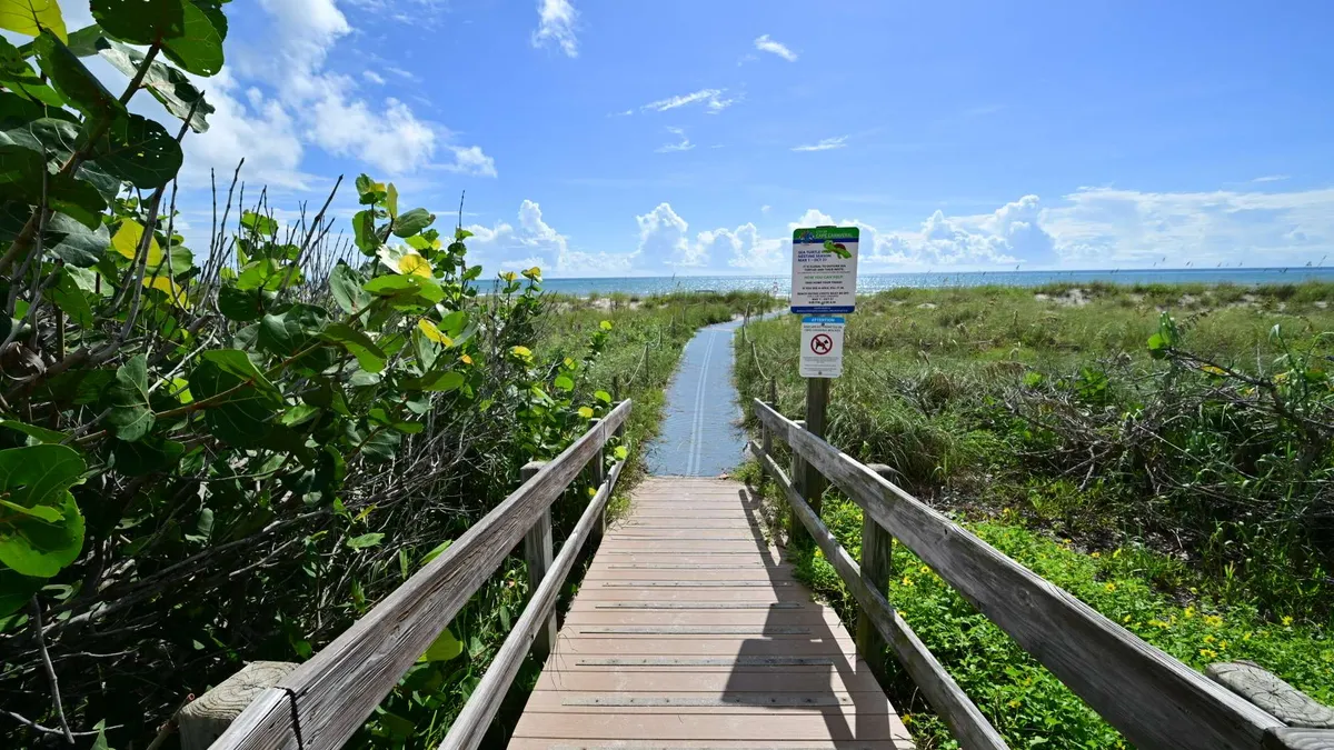 Boardwalk descending through the dunes to the beach