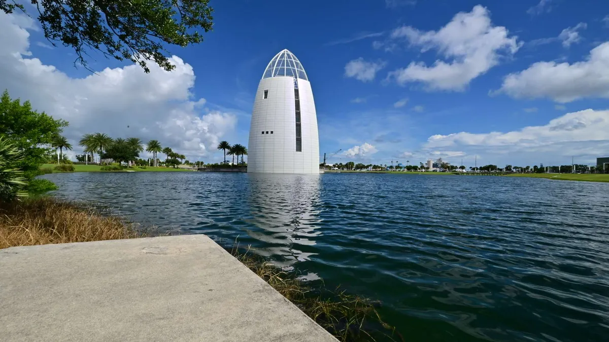 The white harbor light standing in the water
