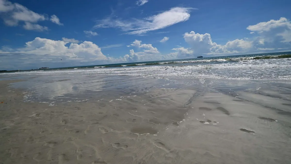 Lines of surf combed smooth by the tide