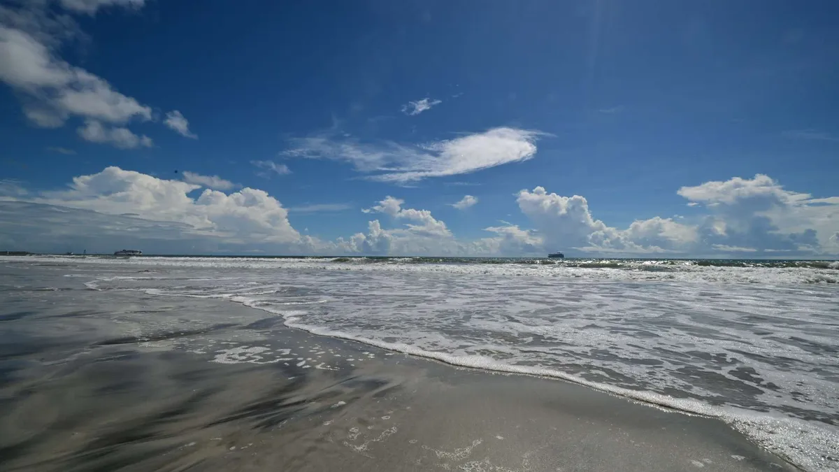 Atlantic waves under a cloud-stitched sky