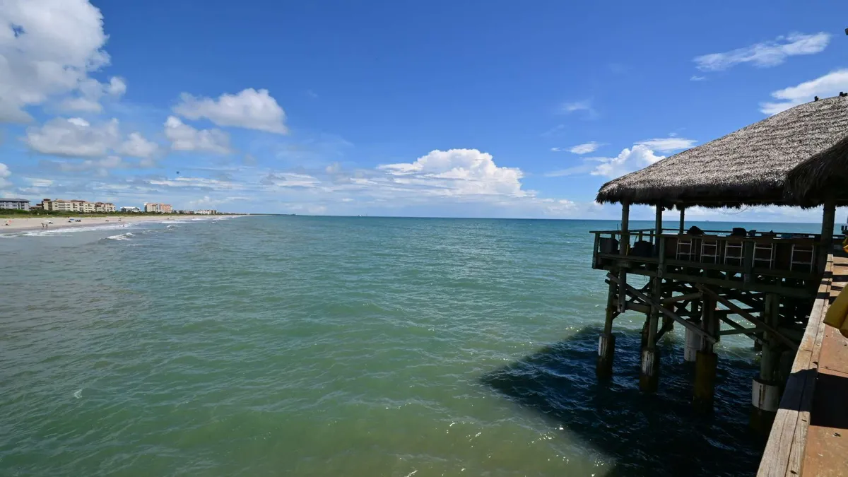 A thatched cabana at the end of the pier