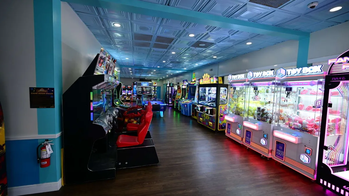Rows of games glowing inside the arcade