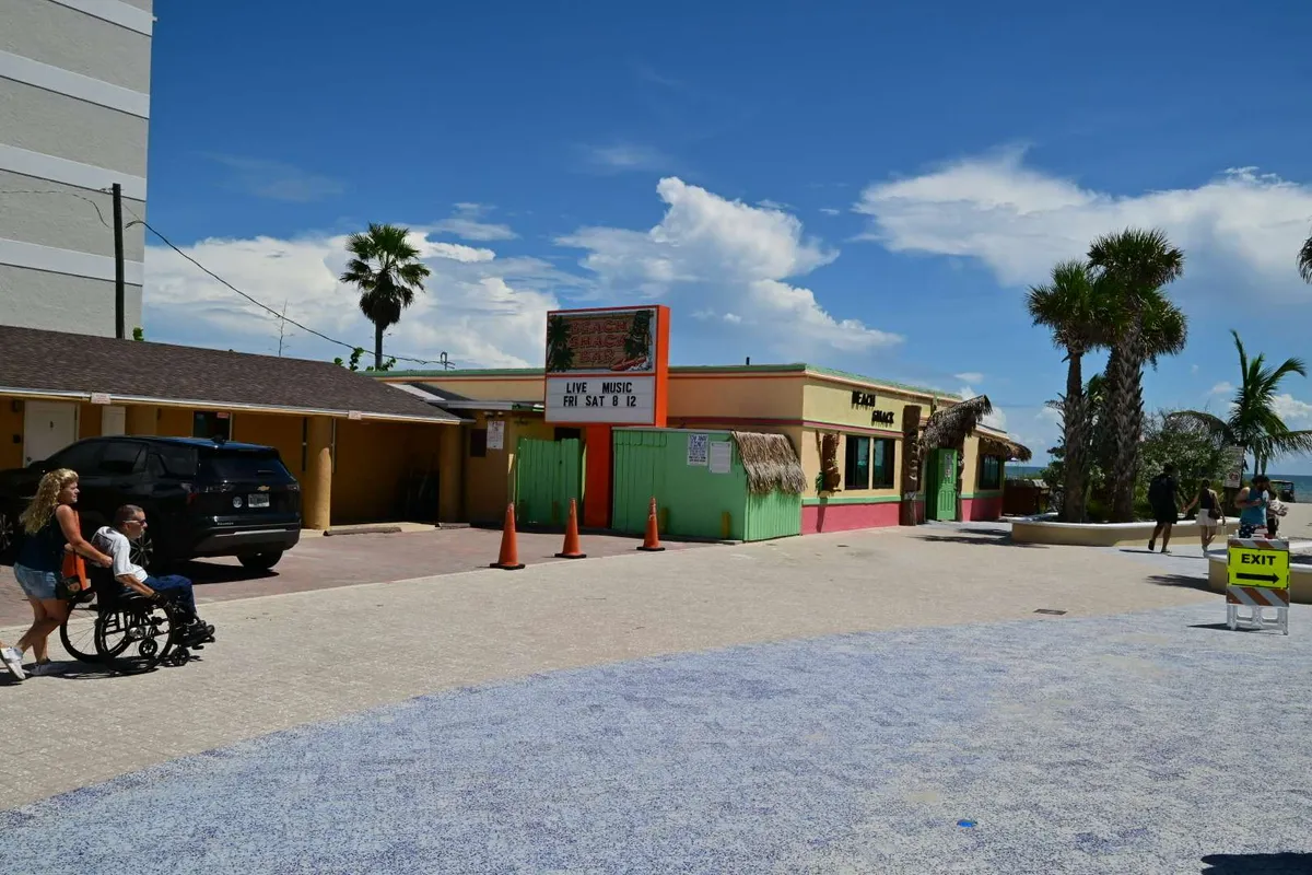 Pastel beach shops under a clear sky