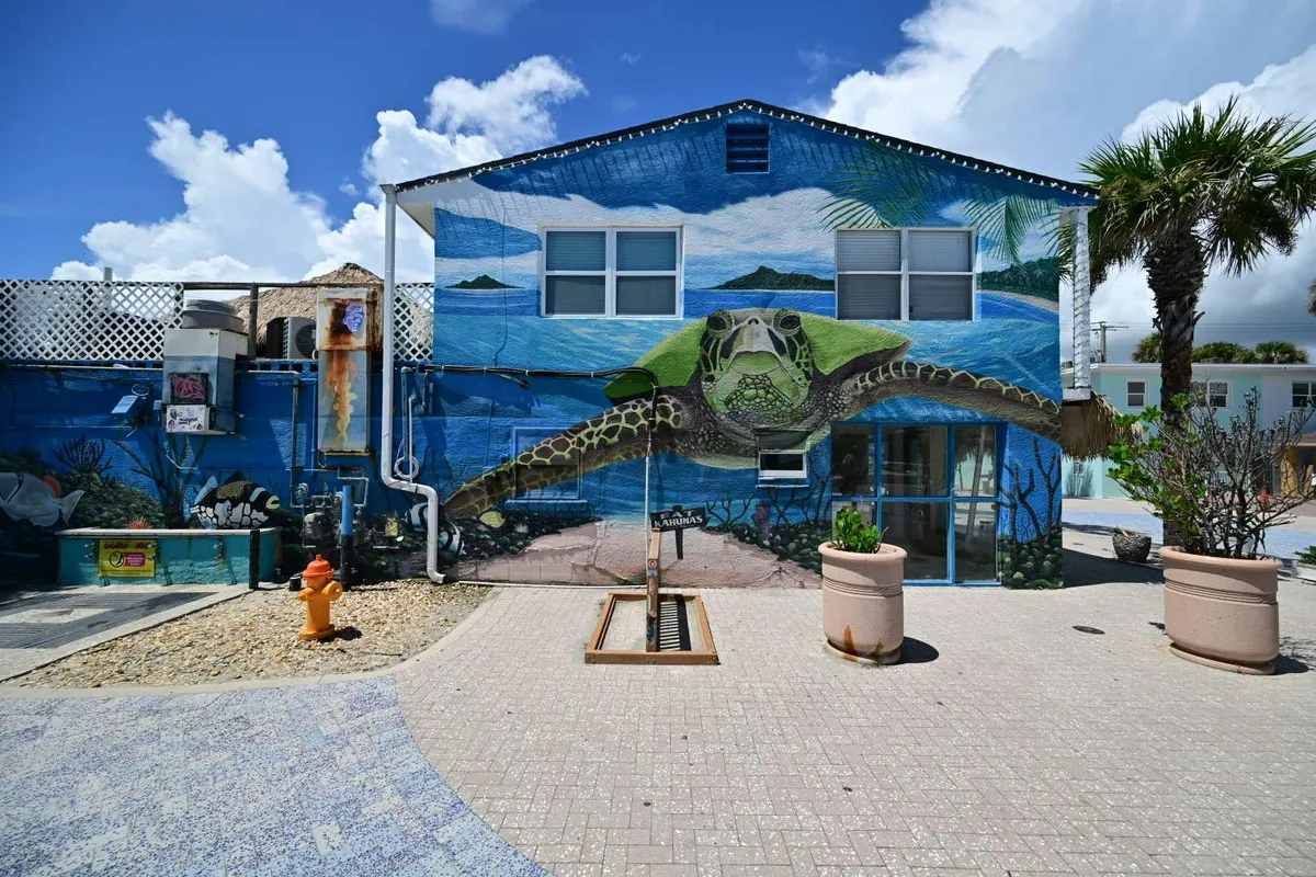 A dragon mural wrapping a seaside wall